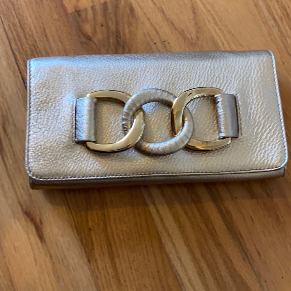 Gold Michael Kors clutch with should strap